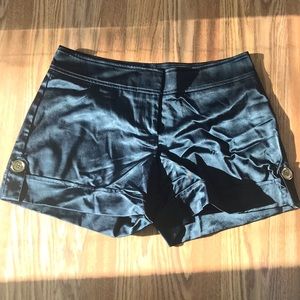 Black silk shorts with buttons on the side.
